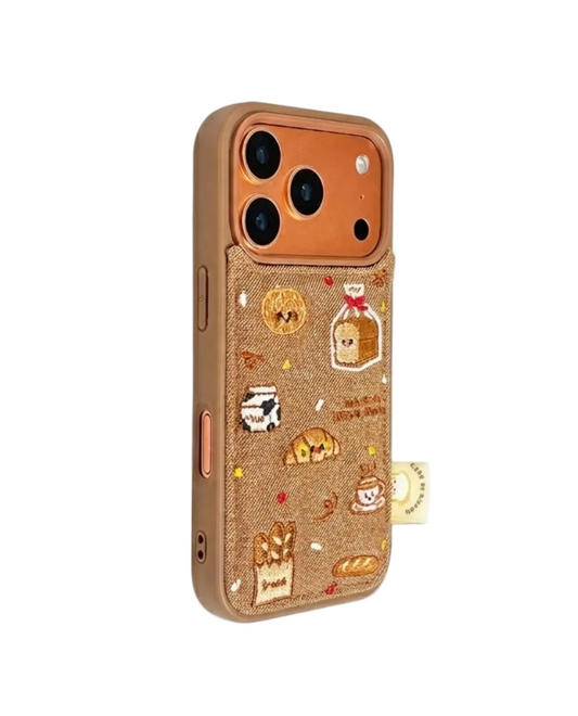 Side perspective of the CasePoppi Bakery Run phone case, highlighting the raised embroidery texture and protective camera ring.