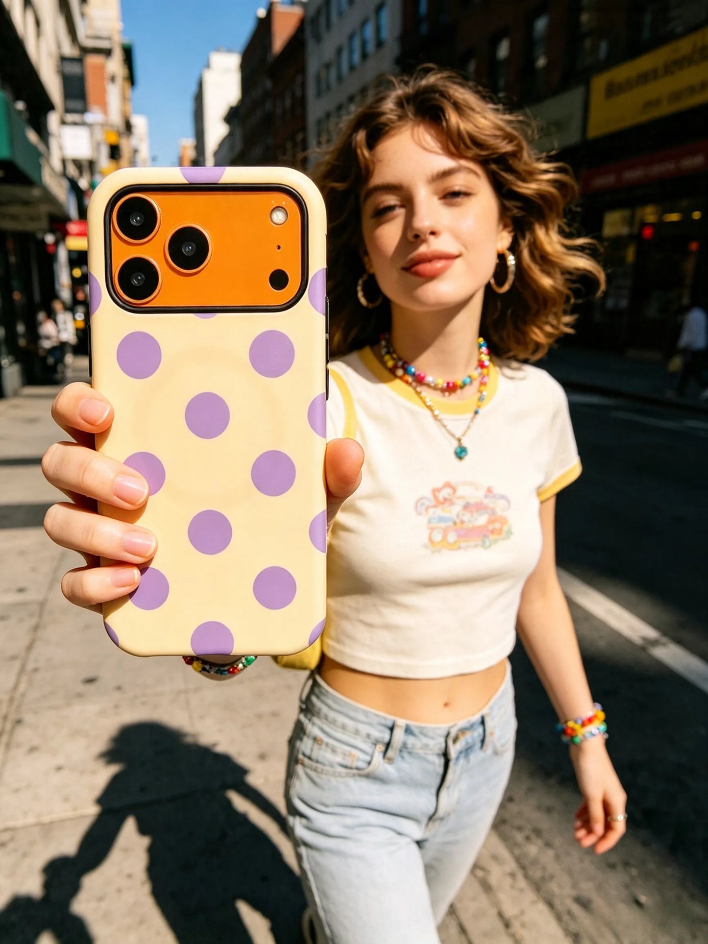 Two women taking selfie with butter yellow polka dot MagSafe phone case