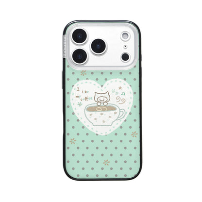 A mint green iPhone case with small grey polka dots, featuring a white lace heart and a cute kitten peeking out of a coffee cup with the text "I like my coffee".