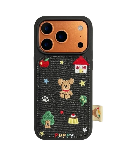 CasePoppi phone case featuring a cute embroidered teddy bear, red house, and apple design on a dark textured background.