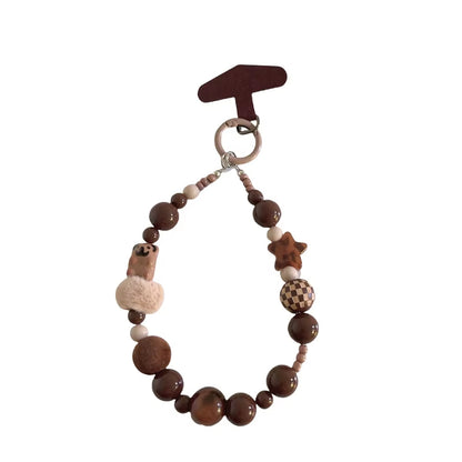 CasePoppi Cozy Milk Tea Beaded Phone Charm, featuring soft fluffy pompom beads, matte brown wood beads, houndstooth patterned beads, and natural stone accents.