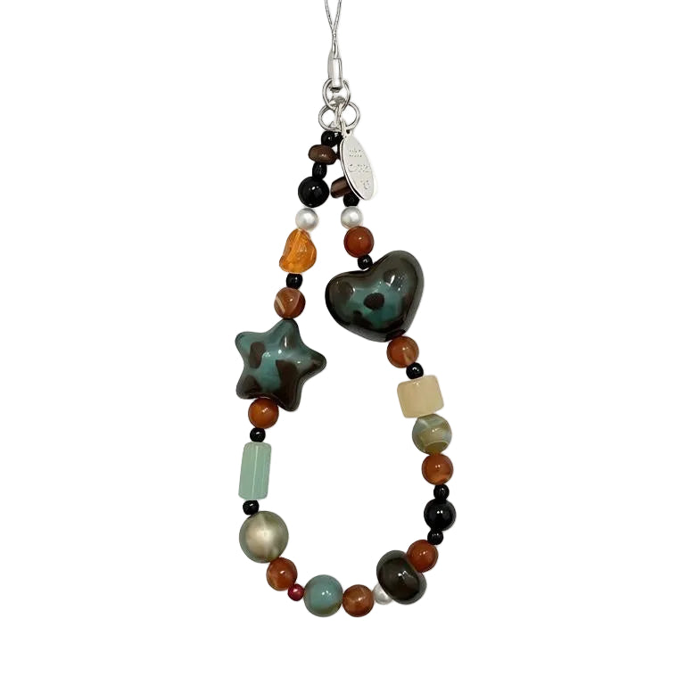 CasePoppi Vintage Boho Beaded Phone Charm, featuring speckled green ceramic heart and star beads, amber acrylic beads, and rustic natural stone beads.