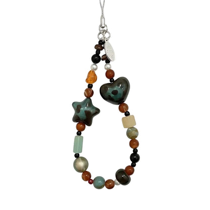 CasePoppi Vintage Boho Beaded Phone Charm, featuring speckled green ceramic heart and star beads, amber acrylic beads, and rustic natural stone beads.