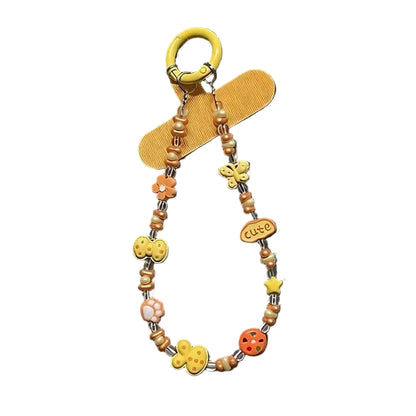 CasePoppi Kidcore Aesthetic Beaded Phone Charm, cream orange cord with smiley face, duck, flower, bow-tie beads, and a 'cute' charm.