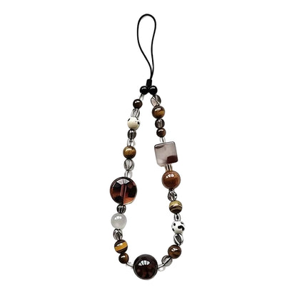 Beaded phone strap with brown, black, and white beads on a white background
