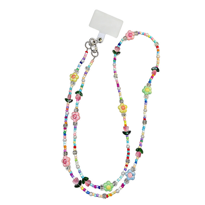Colorful beaded lanyard with floral decorations on a white background