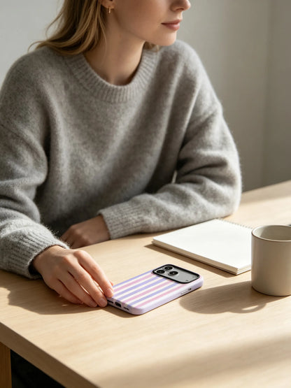 Woman holding lilac purple striped phone case at desk