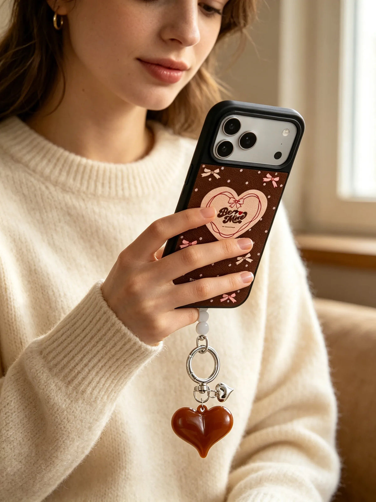 Woman holding vintage heart polka dot phone case with red heart charm